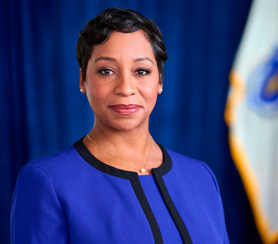 Andrea Joy Campbell portrait photo with Massachusetts state flag