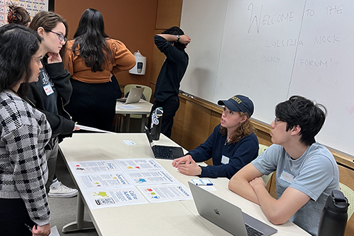 Students standing together around a table