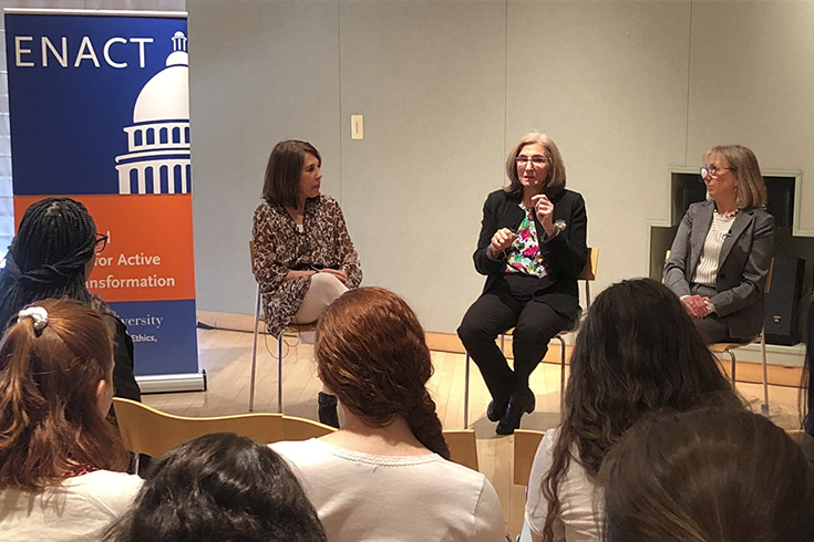 women presenting with ENACT banner in the background