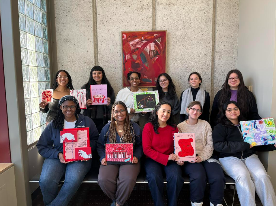 Group of people all sitting smiling at the camera