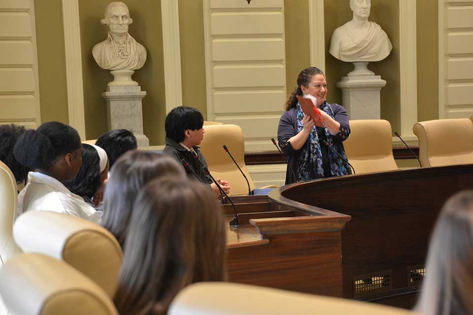 Sen. Rausch talks with Brandeis students in the Senate Chamber.