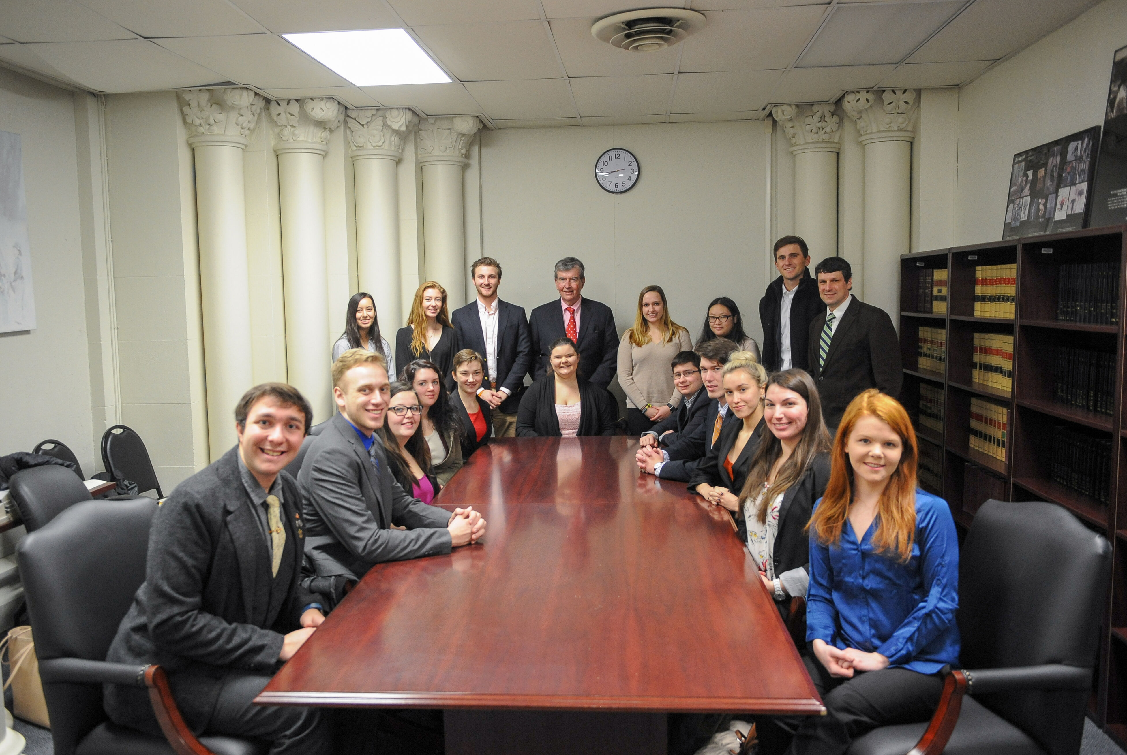 Siena College ENACT students meet with New York State Senator Neil D. Breslin in a meeting room at the New York State Capitol in 2018.