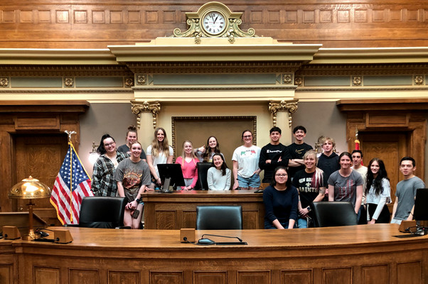 photo of ENACT Faculty Fellow Lily Rowen with her ENACT class at the dais of the Wyoming State Capitol