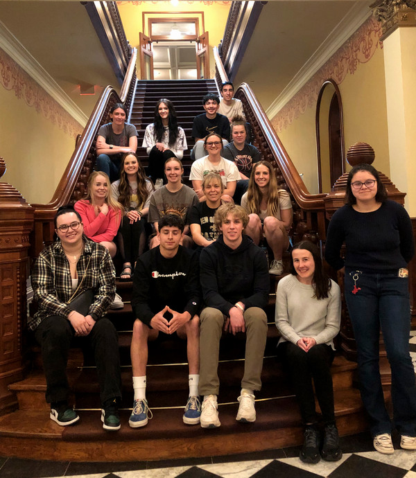 ENACT Faculty Fellow Lily Rowen with ENACT students on the steps of a stairway in the Wyoming State Capitol building
