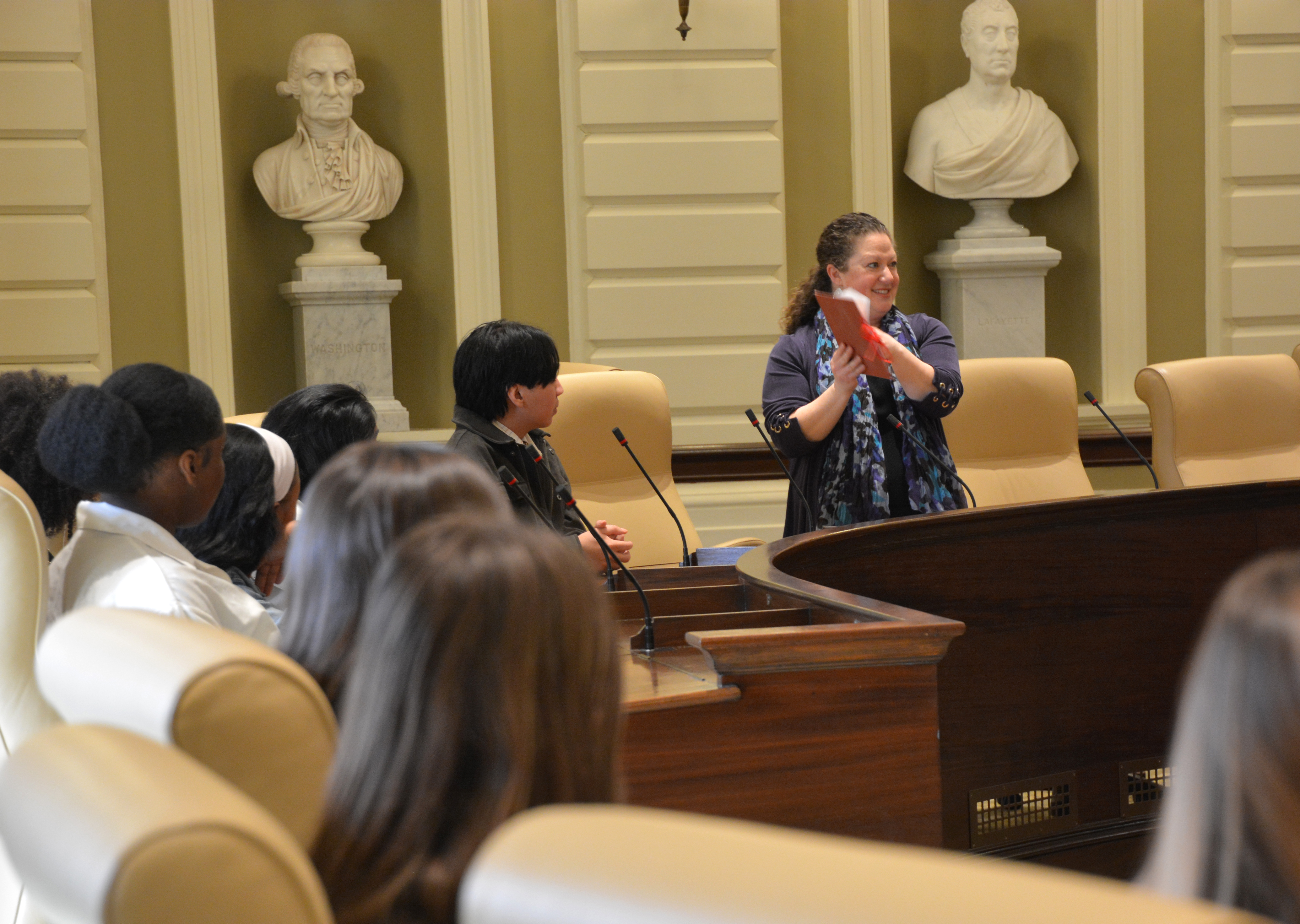 Sen. Rausch talks with Brandeis students in the Senate Chamber.