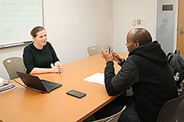 male and female in conversation while sitting across table from each other