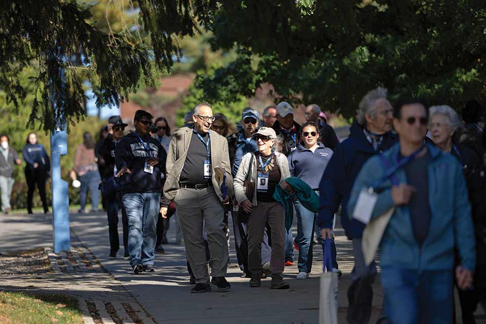 people walking down a path with reunion badges around their necks