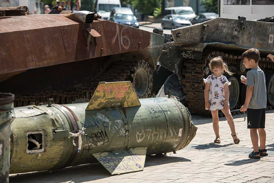 A family with children inspects the fragments of downed missiles, which the Russian army fires at Ukraine