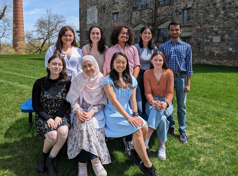 students posed on a picnic table