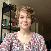 Rachel Dale in front of a bookshelf