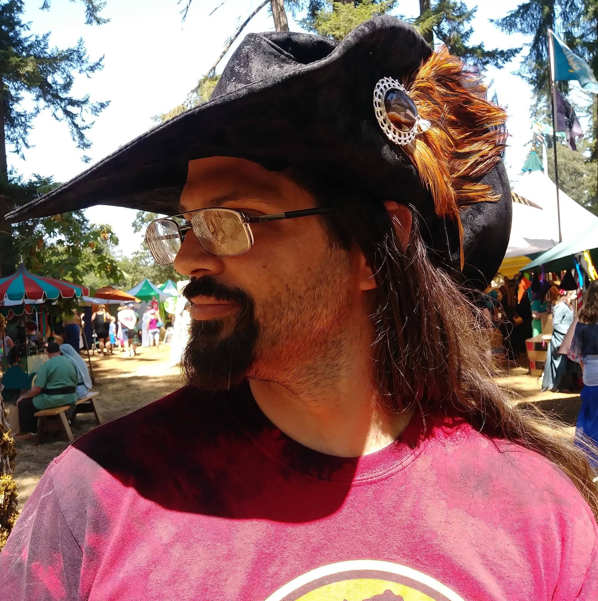 Profile of man with brown hat and feather.
