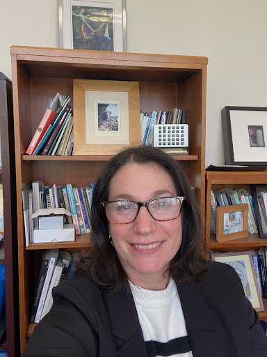 Jennifer Travis in front of a bookshelf