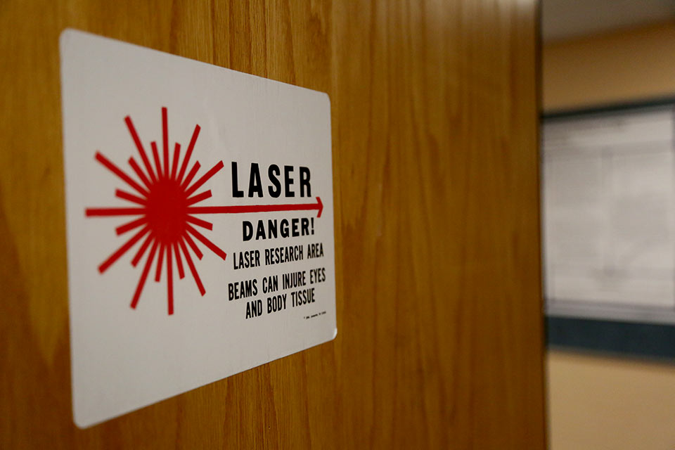 Sign on a door reads: Laser danger, beams can injure eyes and body tissue