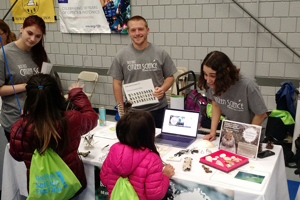 three brandeis students train young students to use an app on their computer