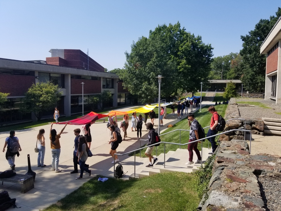 Brandeis students hold the 40m warming stripe banner on campus