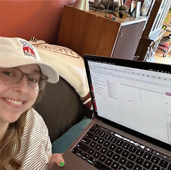 Andie Sheinbaum selfie with laptop working on final report