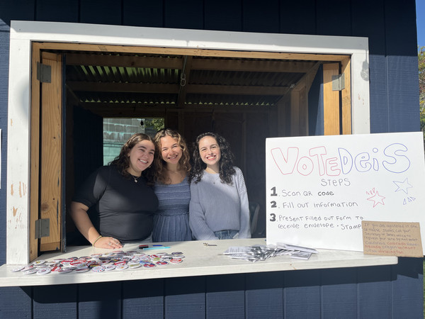 photo of students promoting ENACT Your Vote at Brandeis blue booth