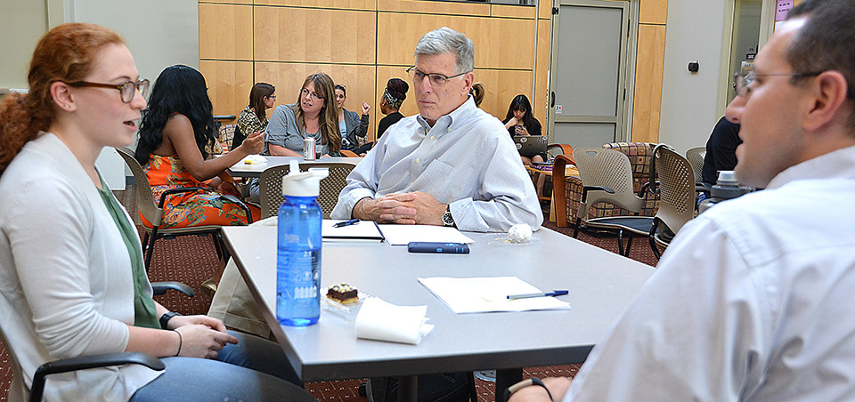 Sage Rosenthal, left, discusses her ENACT experience with faculty fellows Michael Rich of Emory University, center, and Joseph Mead of Cleveland State University.