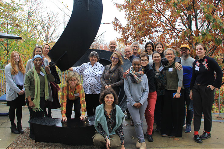 A group of people in front of a large statue