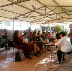 People sitting under a tent