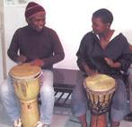 Two people play drums