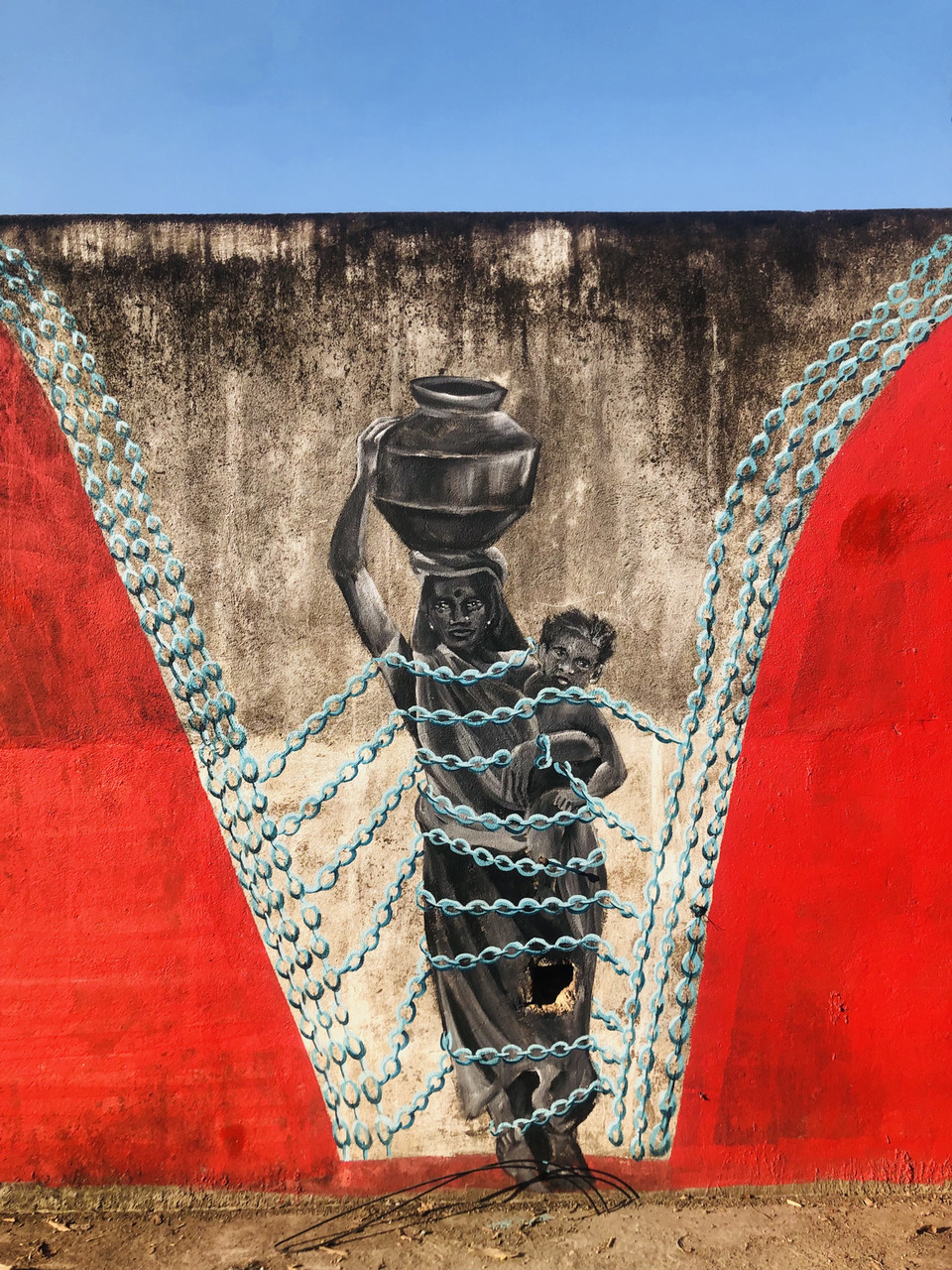 a mural - woman carrying water jar