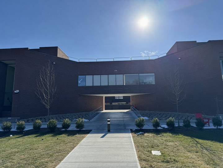 North entrance to Usdan, brick facade with pathways and landscaping.