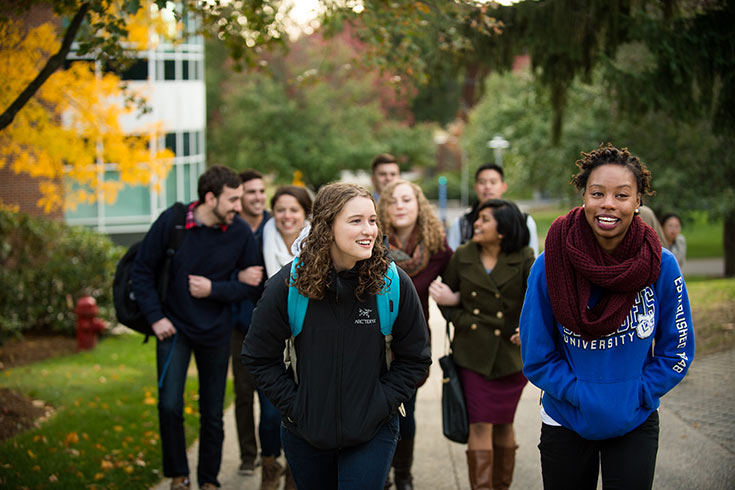 Students walking together on the Brandeis campus in autumn