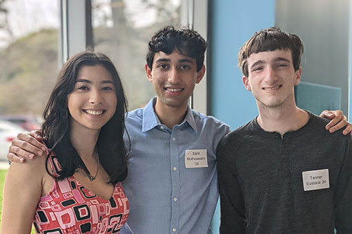 3 Brandeis students smiling 