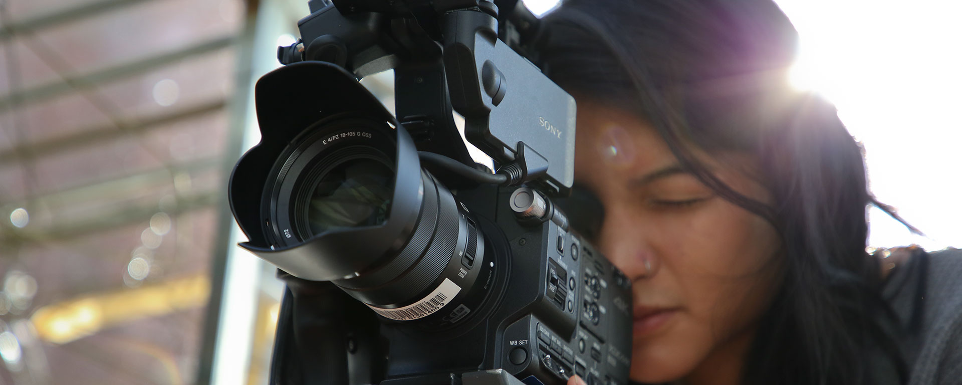 A young woman uses a video camera