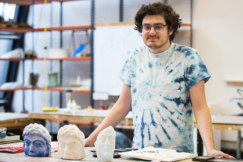 Scott Lerner stands in a sculpture shop