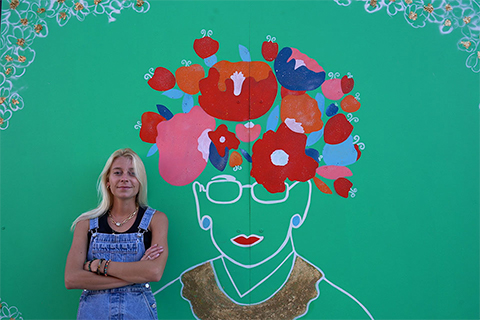 Amelie de Cirfontaine stands in front of her portrait of Ruth Bader Ginsburg; photo credit: Eloise Kim