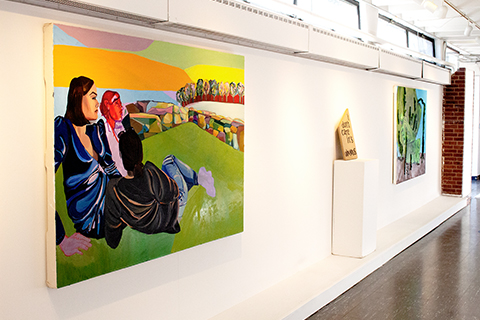 An installation photograph of an Anna Kate Rattray painting, Zoe Gale text on wood, and Sarah Lavin painting.