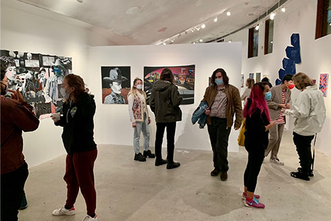 People stand in the Dreitzer Gallery looking at art