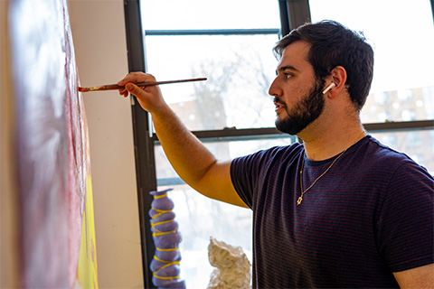 side view of Kauffman painting on a canvas on the wall; painting is barely visible