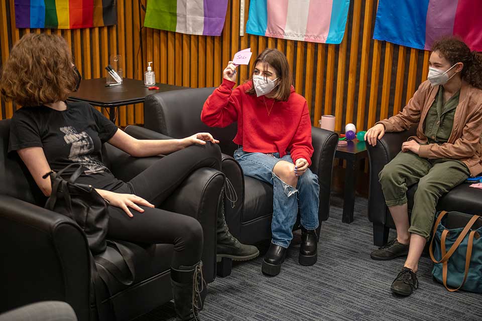 Three students in masks having fun in the GSC