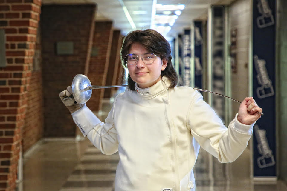 Alexander poses in his fencing uniform.