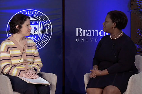 Dr. Tressie McMillan Cottom and Professor Sarah Mayorga sitting in chairs and talking