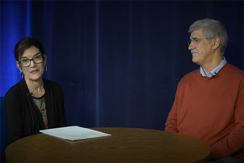 Toni Shapiro-Phim and John Paul Lederach seated at a table