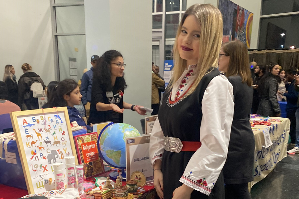 Allie standing in front of the Bulgaria table at the Global Bazaar