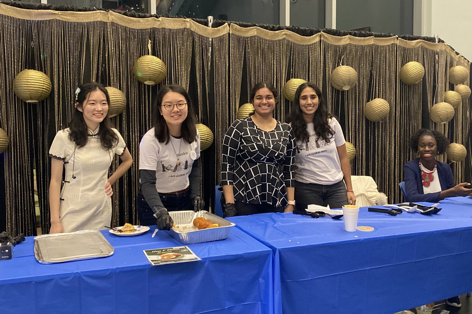 A group of Global Fellows standing at the food table