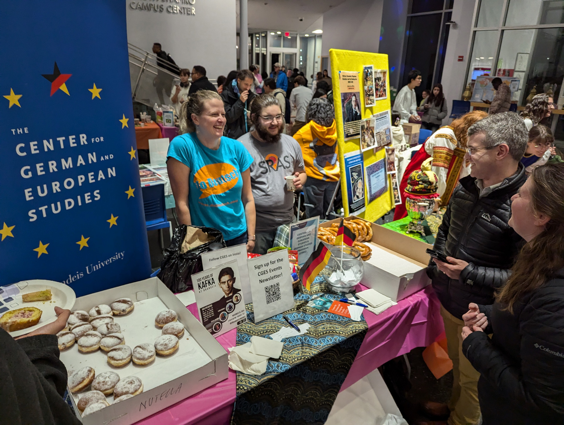 A group of students talking at the German and European Studies table at the Global Bazaar