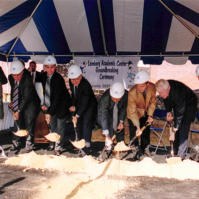 Group of men breaking the ground with packaxes