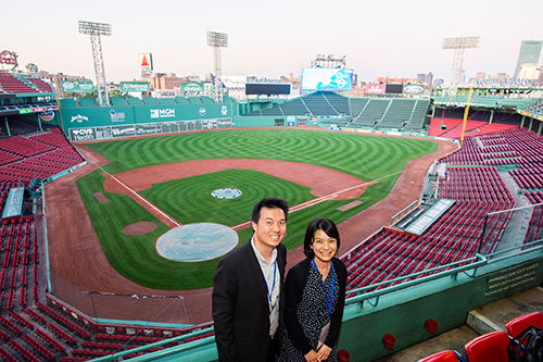 Alumni posing for a photo at Fenway Park