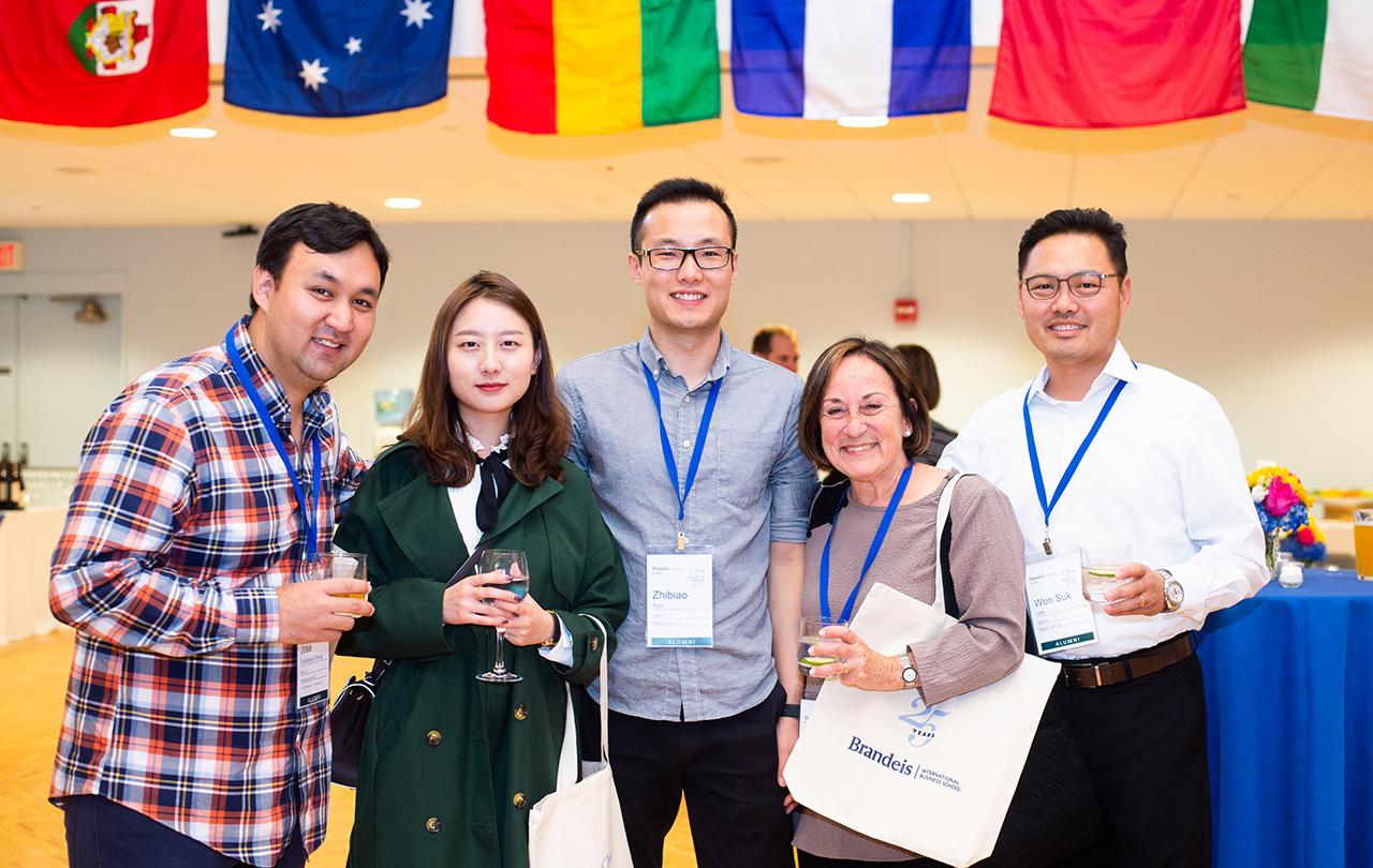 Alumni pose with Viola in Reunion Weekend welcome reception