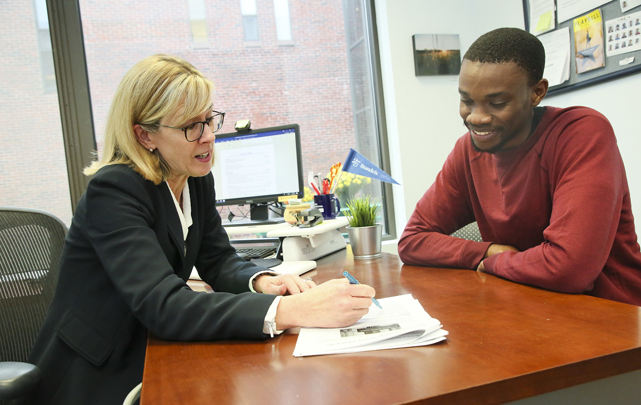 Business school staff member meeting with a student