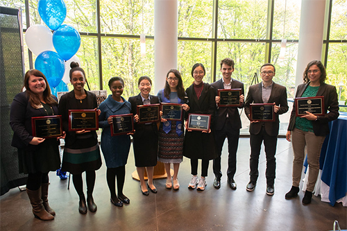 Award recipients pose with their plaques.