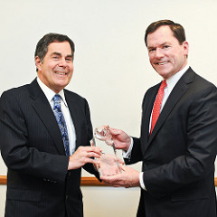 Jay Hooley accepts the Perlmutter Award from Dean Bruce Magid