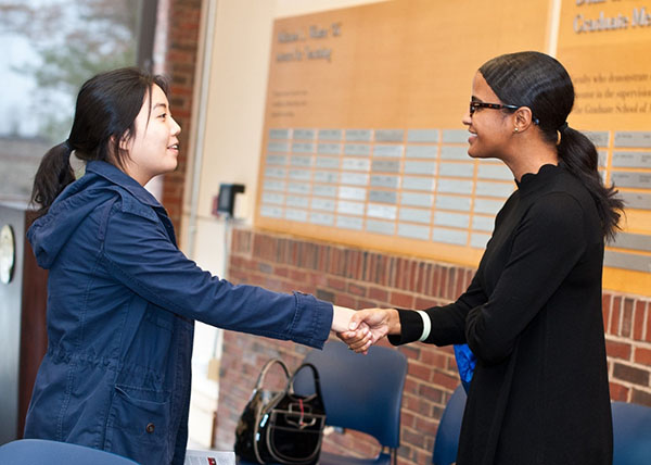 two women shaking hands