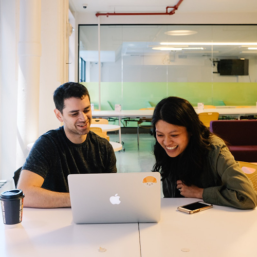 Two people looking at a computer